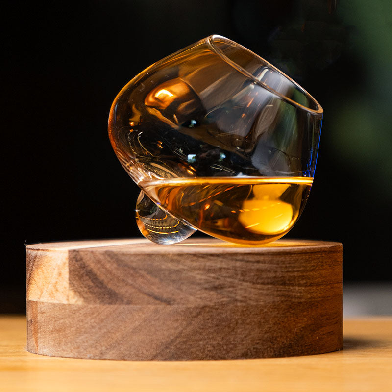 crystal aequilibrium distillate glass by audacem on wooden handcrafted coaster for whiskey, liquors and spirits